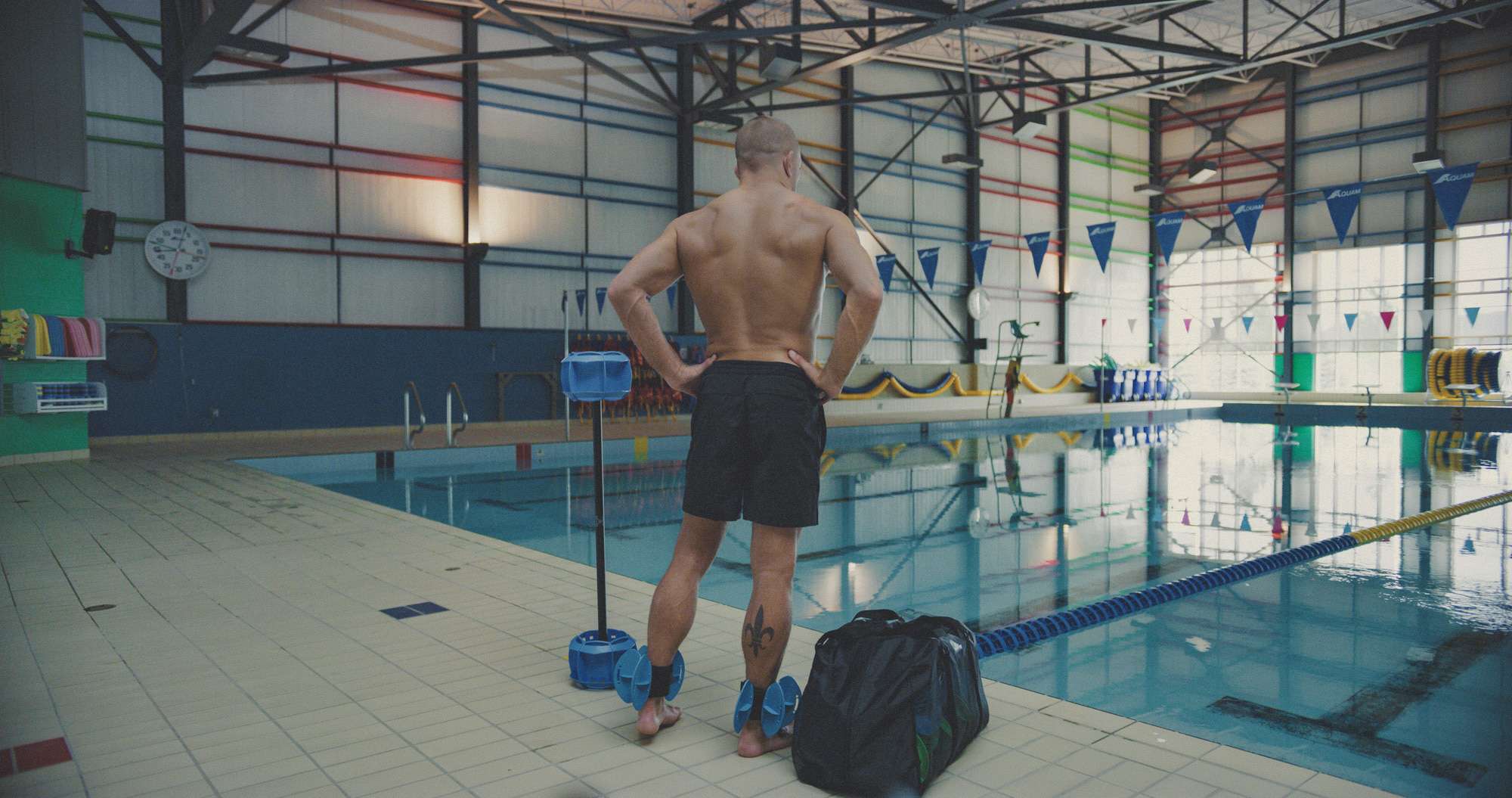 Photo of man getting ready to swim with aqua strength training weights made from Texspec Neoprene